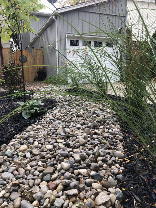 Dry river bed using river stones. A project by the London Ontario based O'Connor Stone & Landscape