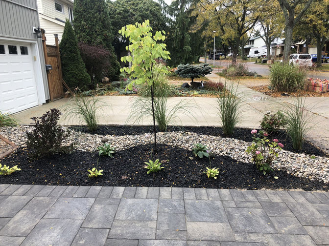 Driveway side landscape. A dpaver riveway and landscape project by O'Connor Stone & Landscape, a landscape and hardscape contractor in London Ontario.