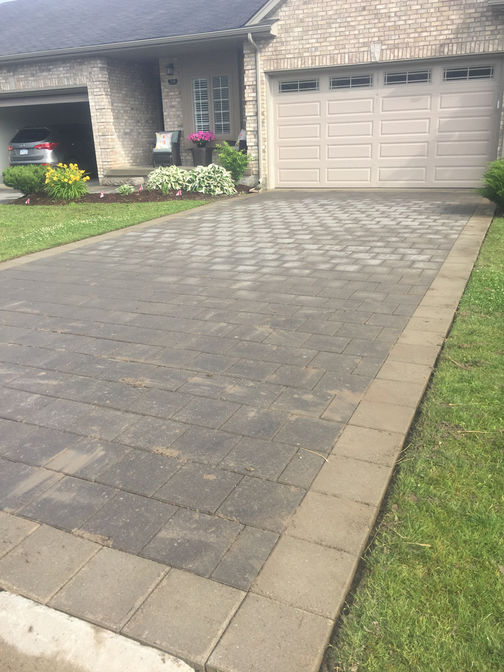 Driveway level and brick paver relay. A paver driveway project in London Ontario region by O'Connor Stone & Landscape