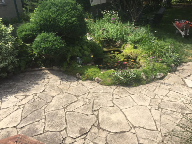 Pond with stone and waterfall. A water feature project by O'Connor Stone & Landscape