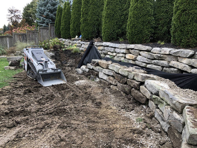 Armour stone wall. A retaining wall project by the London Ontario based O'Connor Stone & Landscape